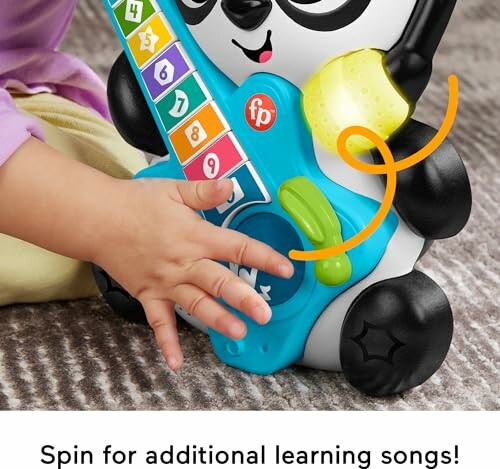 A child playing with a panda-shaped toy guitar.