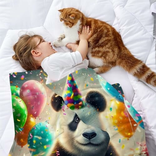 Child lying on bed with cat and panda-themed blanket