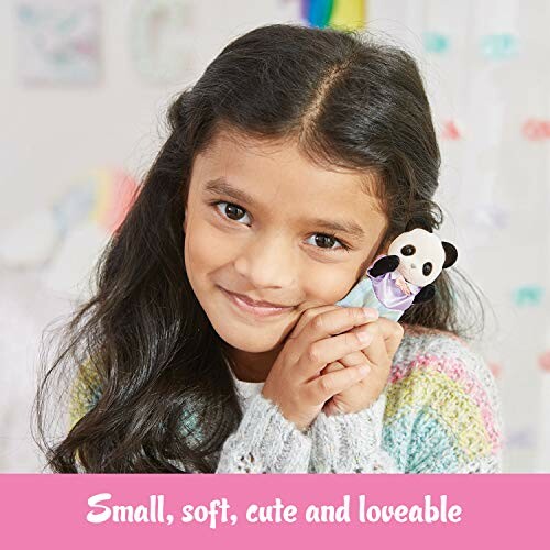 A girl holding a small panda toy, smiling, perfect for kids and collectors alike!