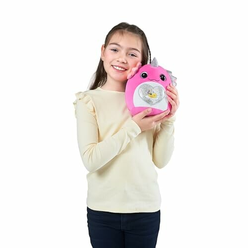 Girl holding a pink unicorn plush toy