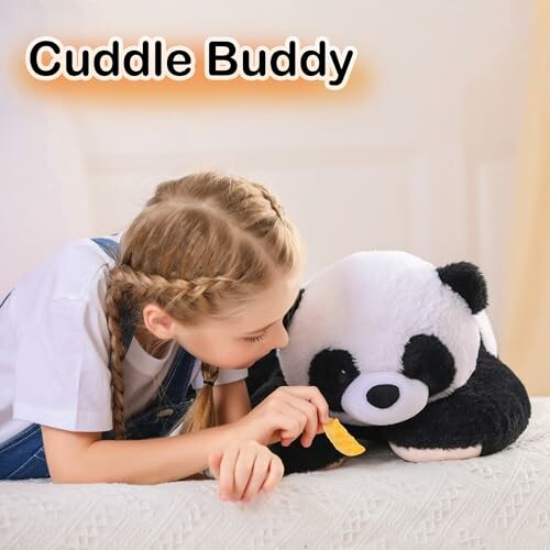 Young girl playing with a panda stuffed toy labeled 'Cuddle Buddy'