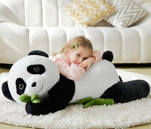 A child hugging a large panda plush toy on a rug, showcasing its impressive size and cuddly appeal.