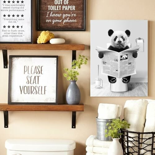 Bathroom wall art with panda reading newspaper on toilet.