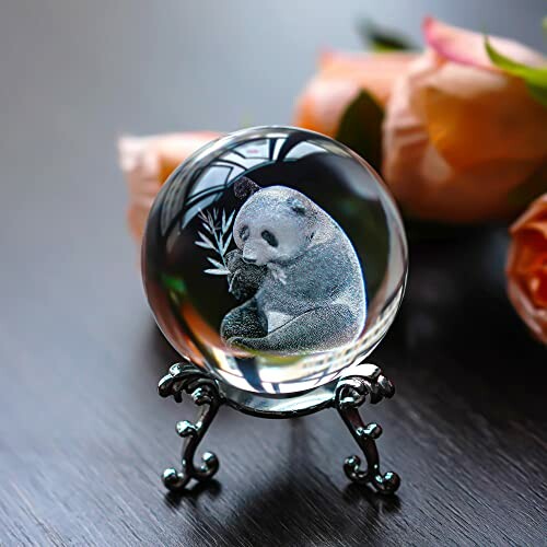 Crystal ball with panda engraving on ornate stand