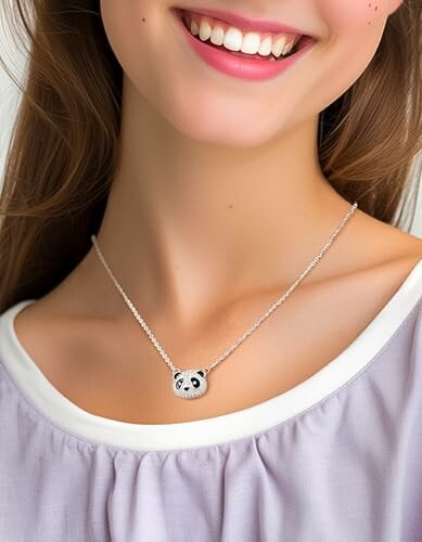 Woman wearing a panda necklace and smiling.