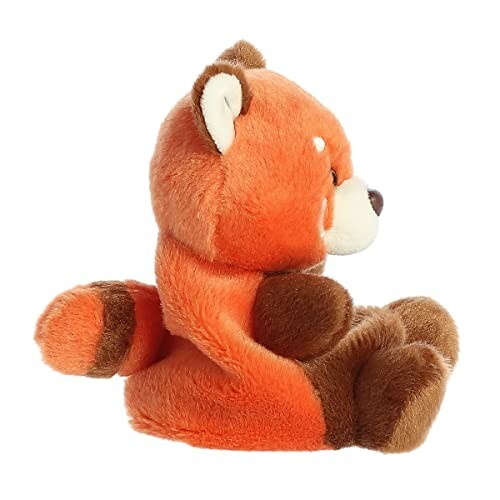 Side view of a plush red panda toy.