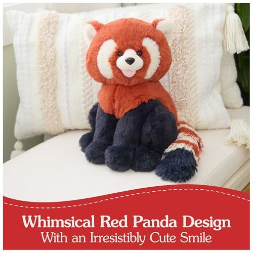 Plush red panda toy with a cute smile on a cushion.