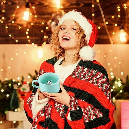 Woman in Santa hat with holiday sweater holding a mug